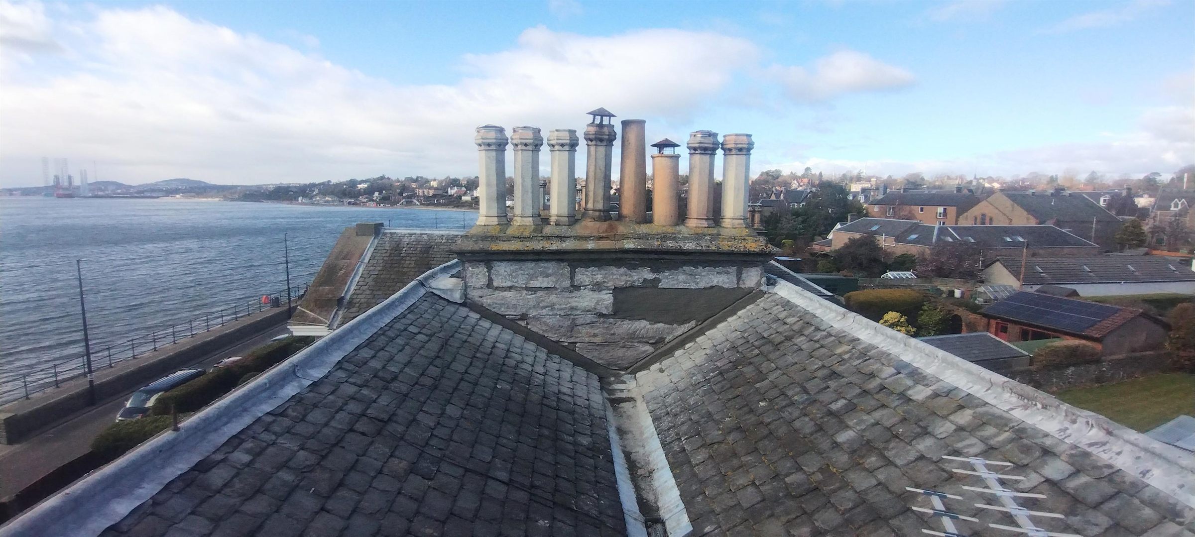 Slates and stack checked over — Slipped slates re-fixed and the chimney head made good on a house looking out across the Tay.