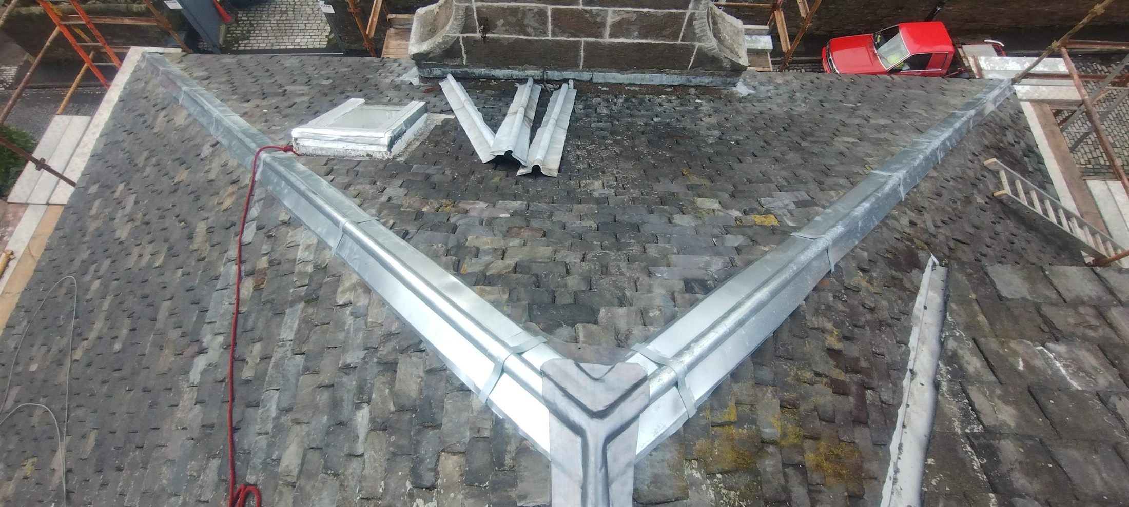 Lead ridge & hips renewed — Old cement ridging stripped off and new lead rolls formed over the apex and down both hips — the joint where most Scots slate roofs start letting water in.
